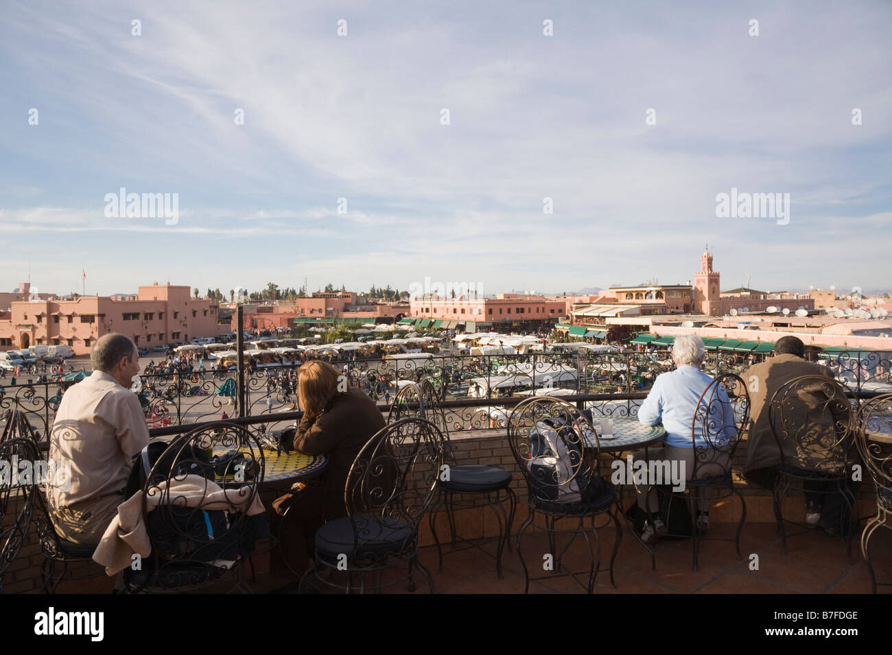 Marrakech Morocco North Africa Tourists in cafe terrace overlooking Place Djemma el Fna square in the Medina Stock Photo