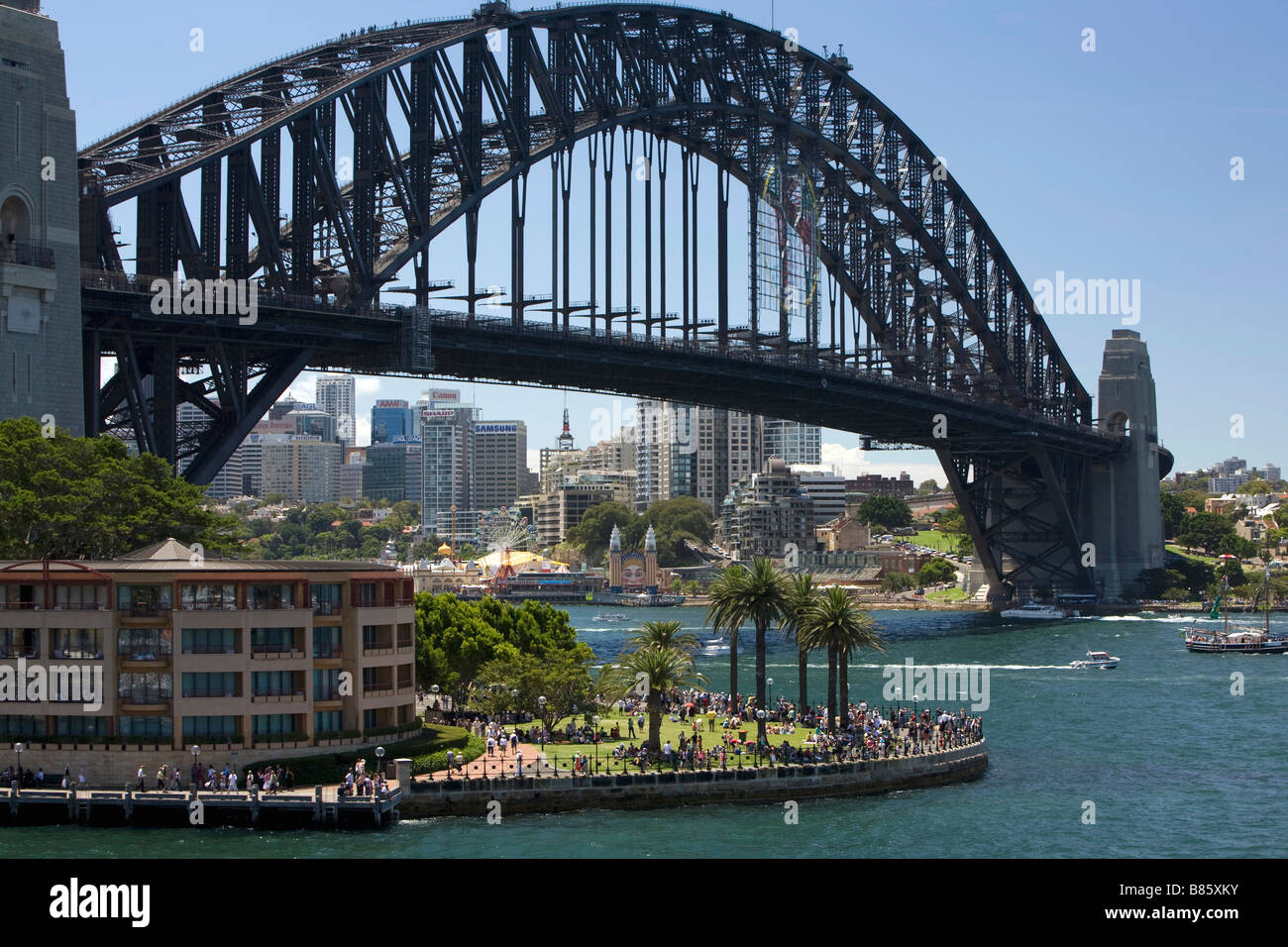 Sydney Harbour Bridge with crowds gathered in Hickson Road reserve beside Sydney Park Hyatt Hotel, Sydney harbour,NSW,Australia Stock Photo