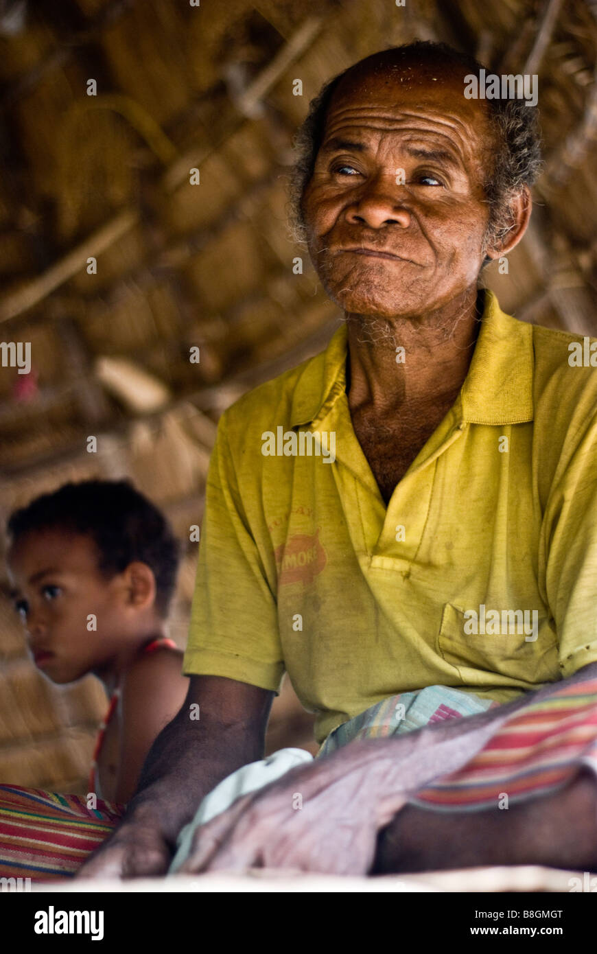 Village elder sits in meeting hut in traditional Timorese village of None near Soe, Indonesia Stock Photo