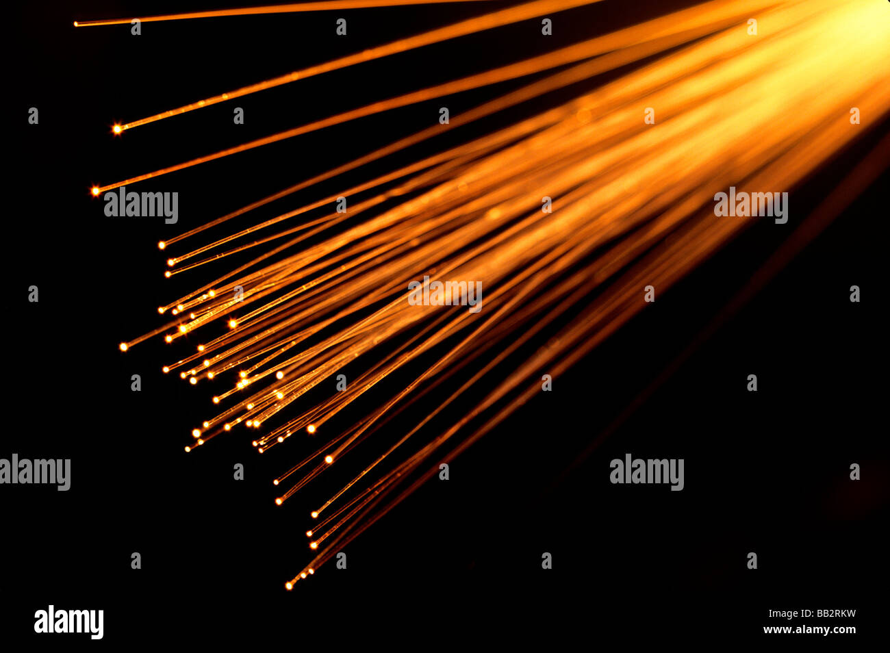 Fiber Optic Strands aglow transmitting light images through transparent fibers. Stock Photo