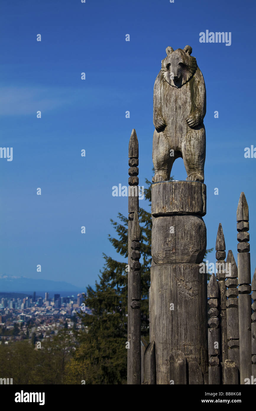 Bear totem in the 'Playground of the Gods' at Burnaby Park with Vancouver, British Columbia, Canada in background. Stock Photo