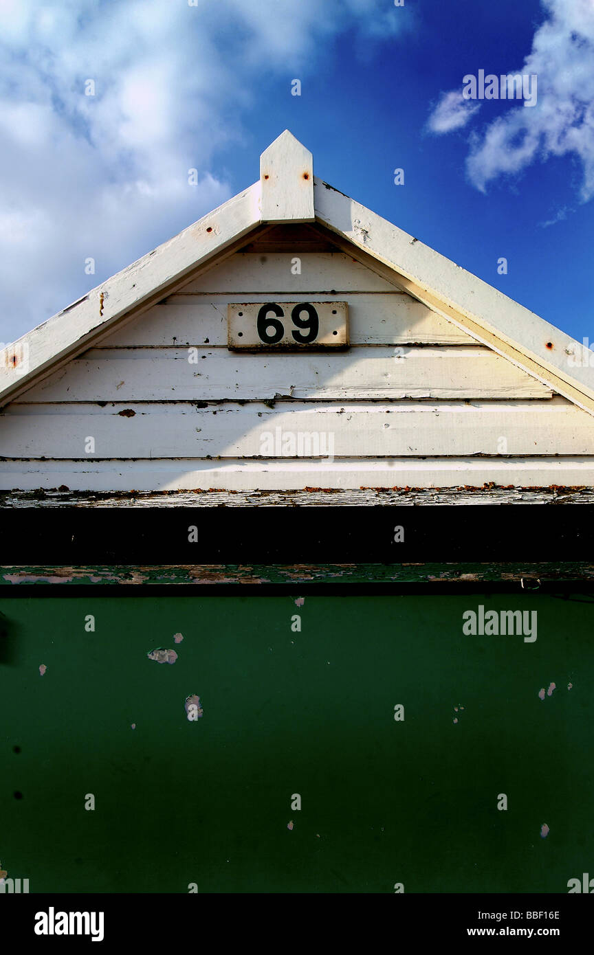 A single hut alomg the beach in dorset with a number 69 Stock Photo