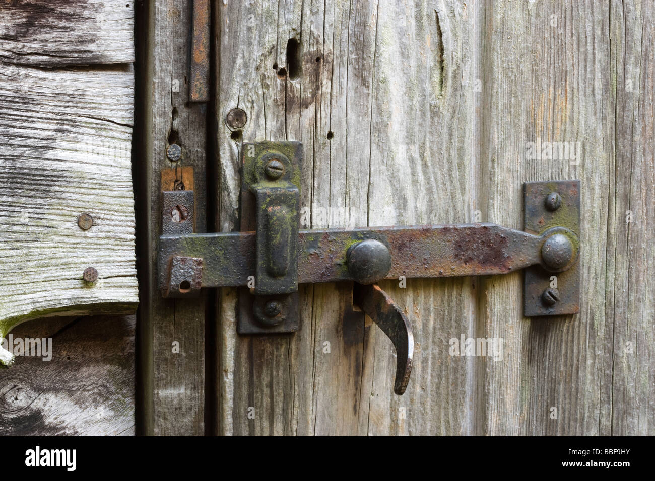 Latch and lock on old shed door. Stock Photo