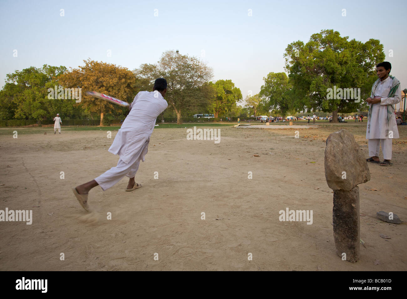 Boys playing cricket in a New Delhi park, India Stock Photo