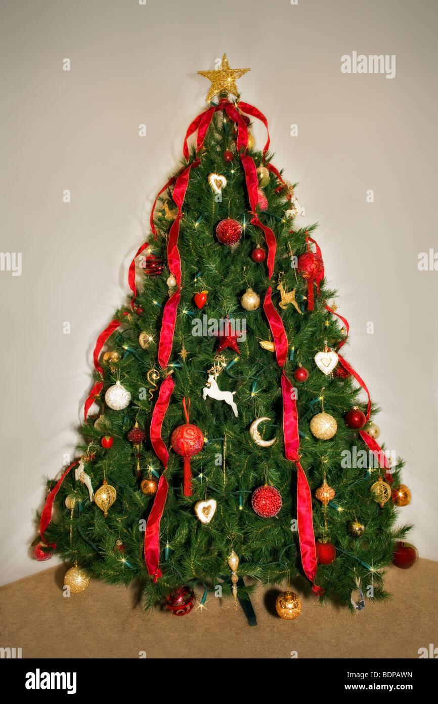 Traditional decorated Christmas tree in red and gold theme Stock Photo