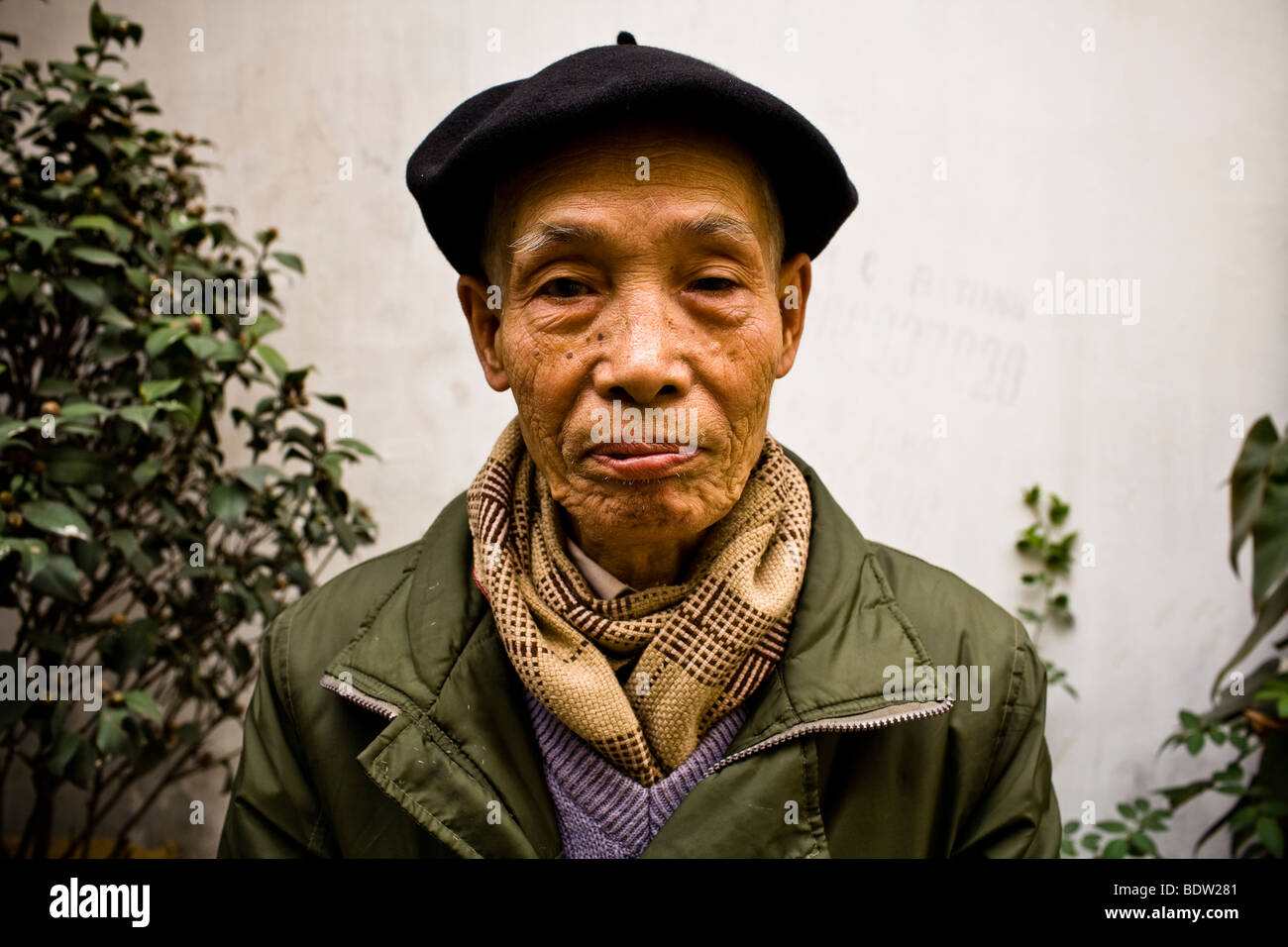 Nguyen Van Hai poses for a portrait outside of his home in the village of Bat Trang, just outside of Hanoi, Vietnam. Stock Photo