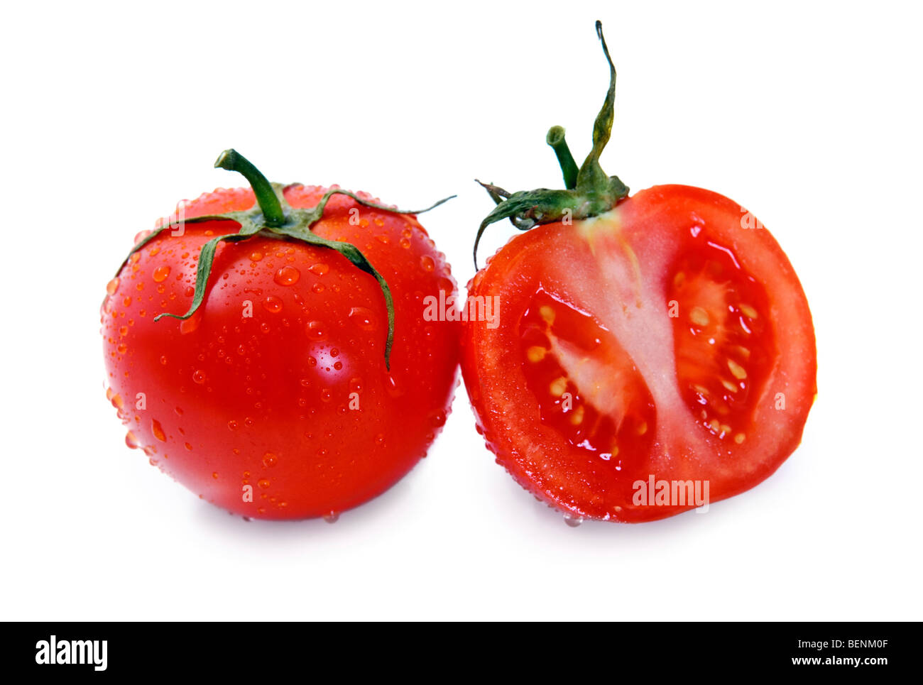 Tomato covered dew drops isolated over white Stock Photo