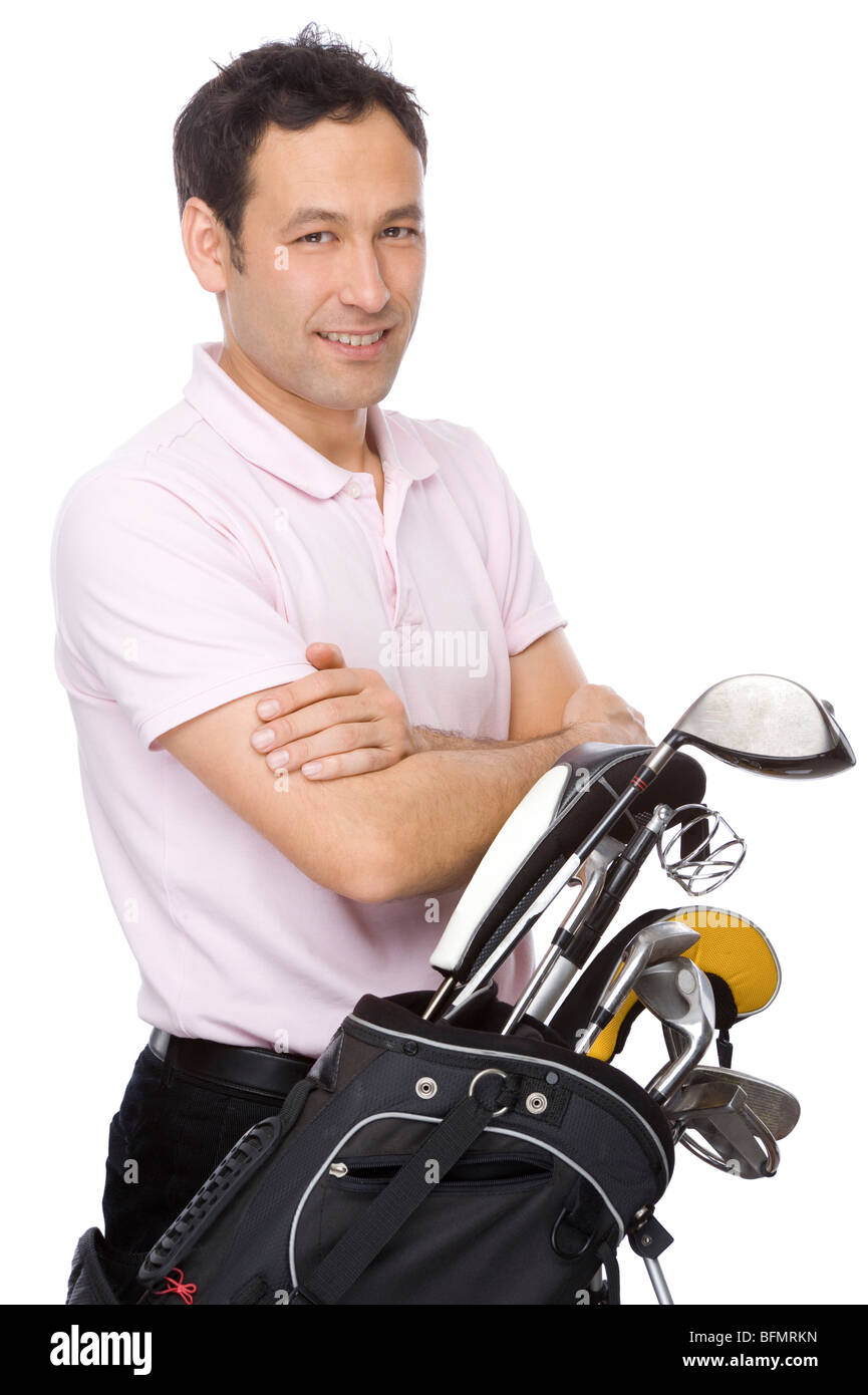 Man standing with his arms crossed near his golf kit Stock Photo