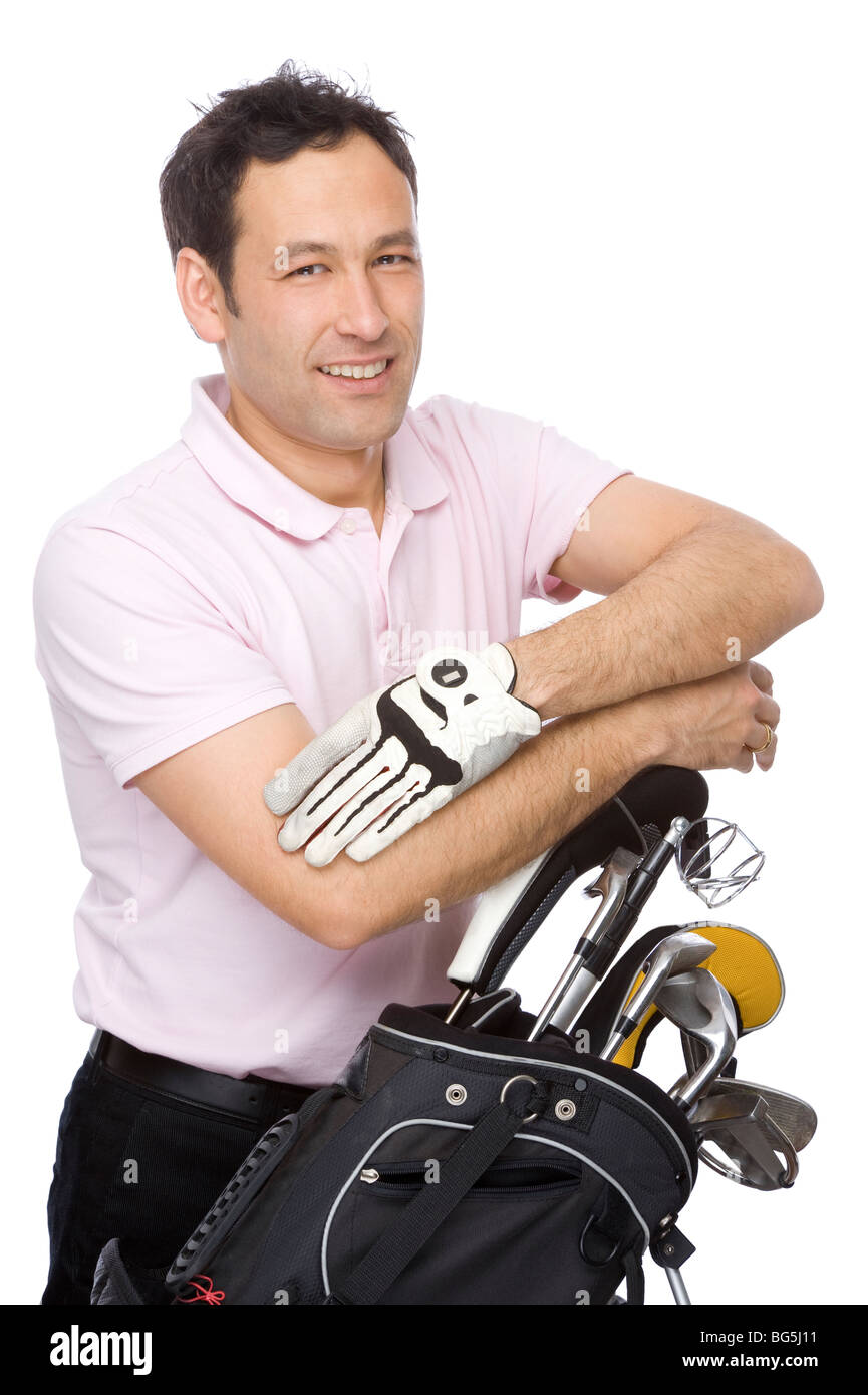 Man standing with his arms crossed near his golf kit Stock Photo