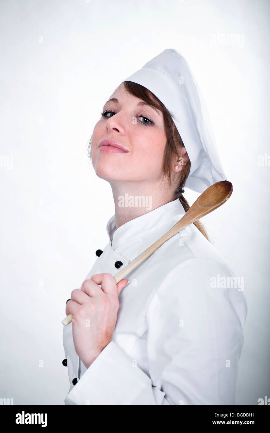 Young chef with a wooden spoon Stock Photo