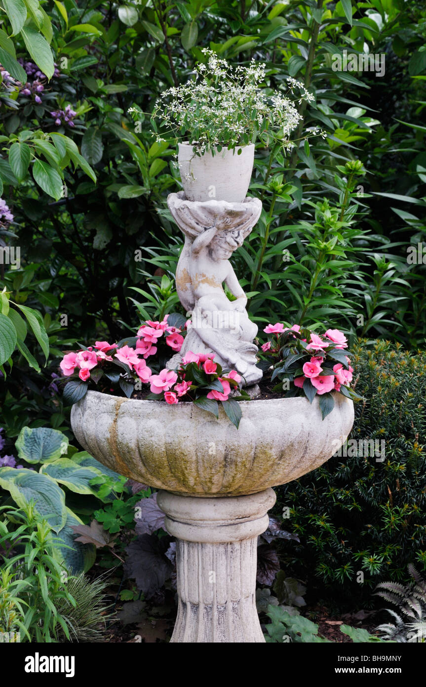 Spurge (Euphorbia hypericifolia 'Diamond Frost') and buzy Lizzie (Impatiens walleriana) in a fountain. Design: Marianne and Detlef Lüdke Stock Photo