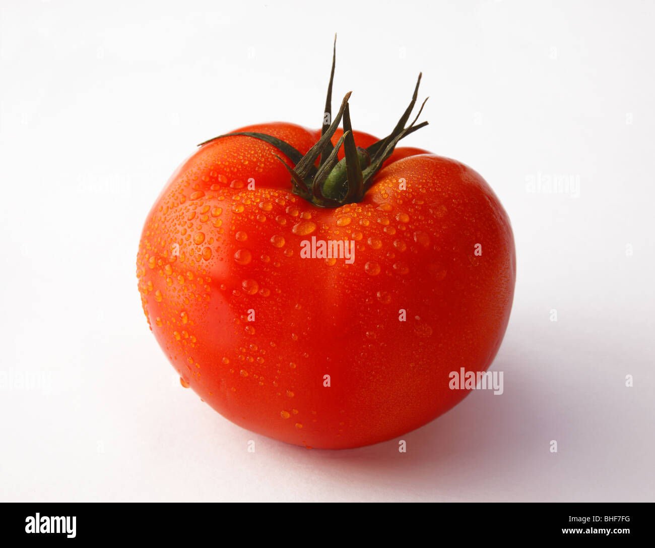 Large, fresh, ripe, red, juicy, organic beef tomato on white background. Stock Photo