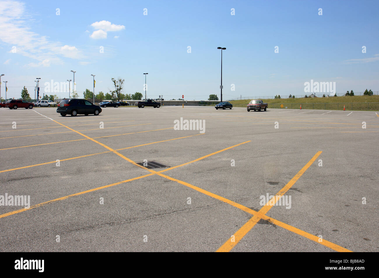 An almost empty supermarket car park with yellow lines, Kendallville, United States of America Stock Photo