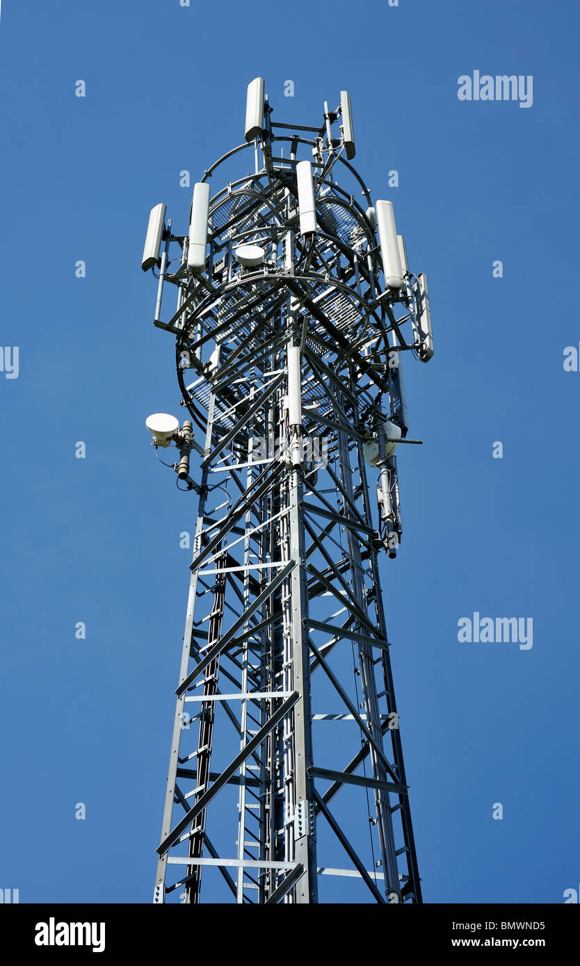 MOBILE PHONE MAST SHOT ON A SUNNY DAY AGAINST A BLUE SKY Stock Photo