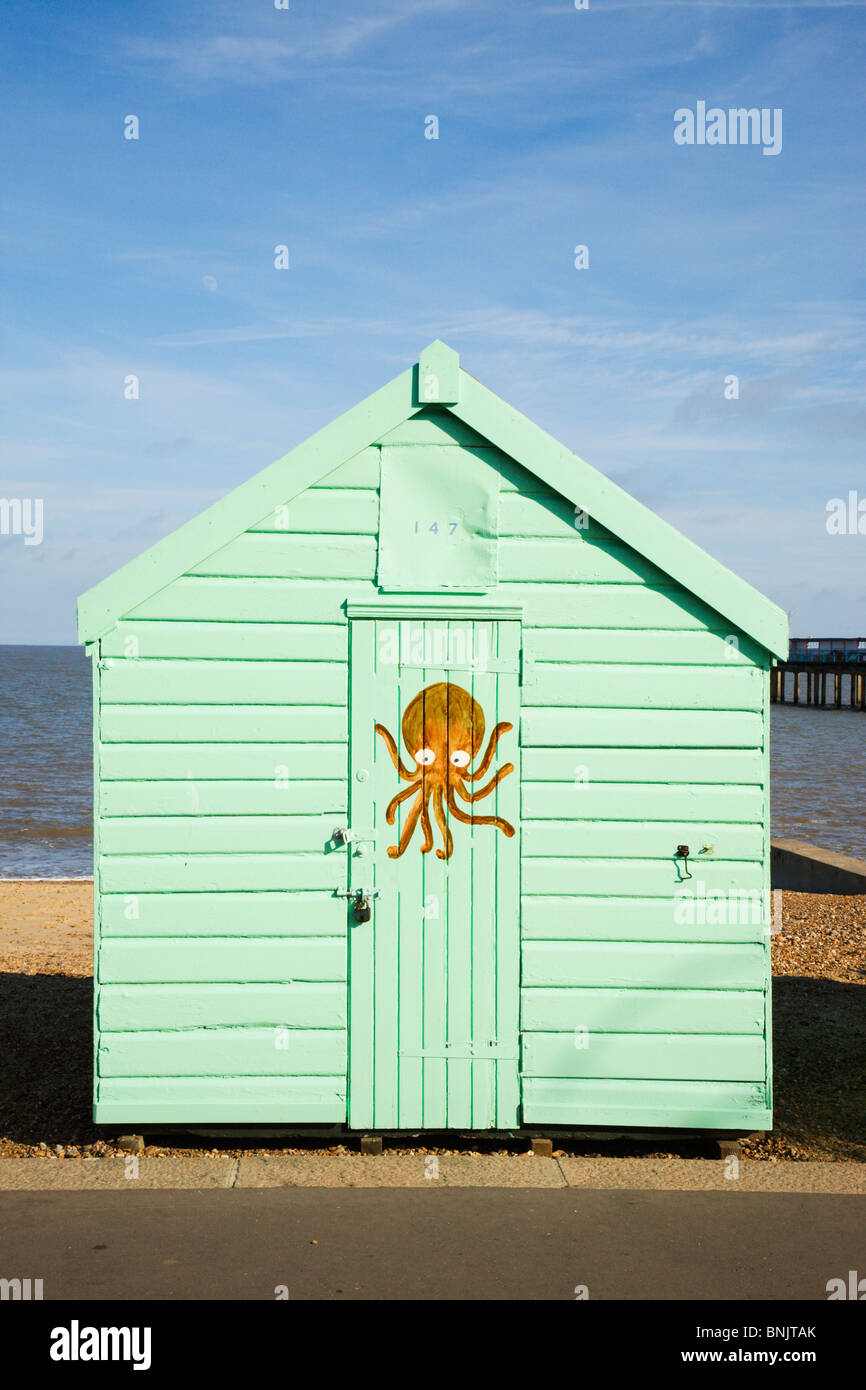 A bright green beach hut with Octopus artwork, Felixstowe, Suffolk. Stock Photo