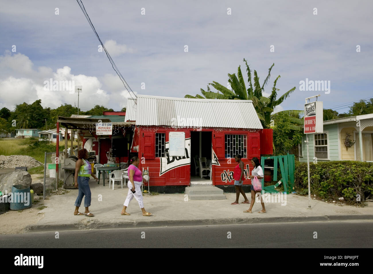 Rum-shop with advertising for Banks Beer with the distinctive black white and red sign in Oistins Stock Photo