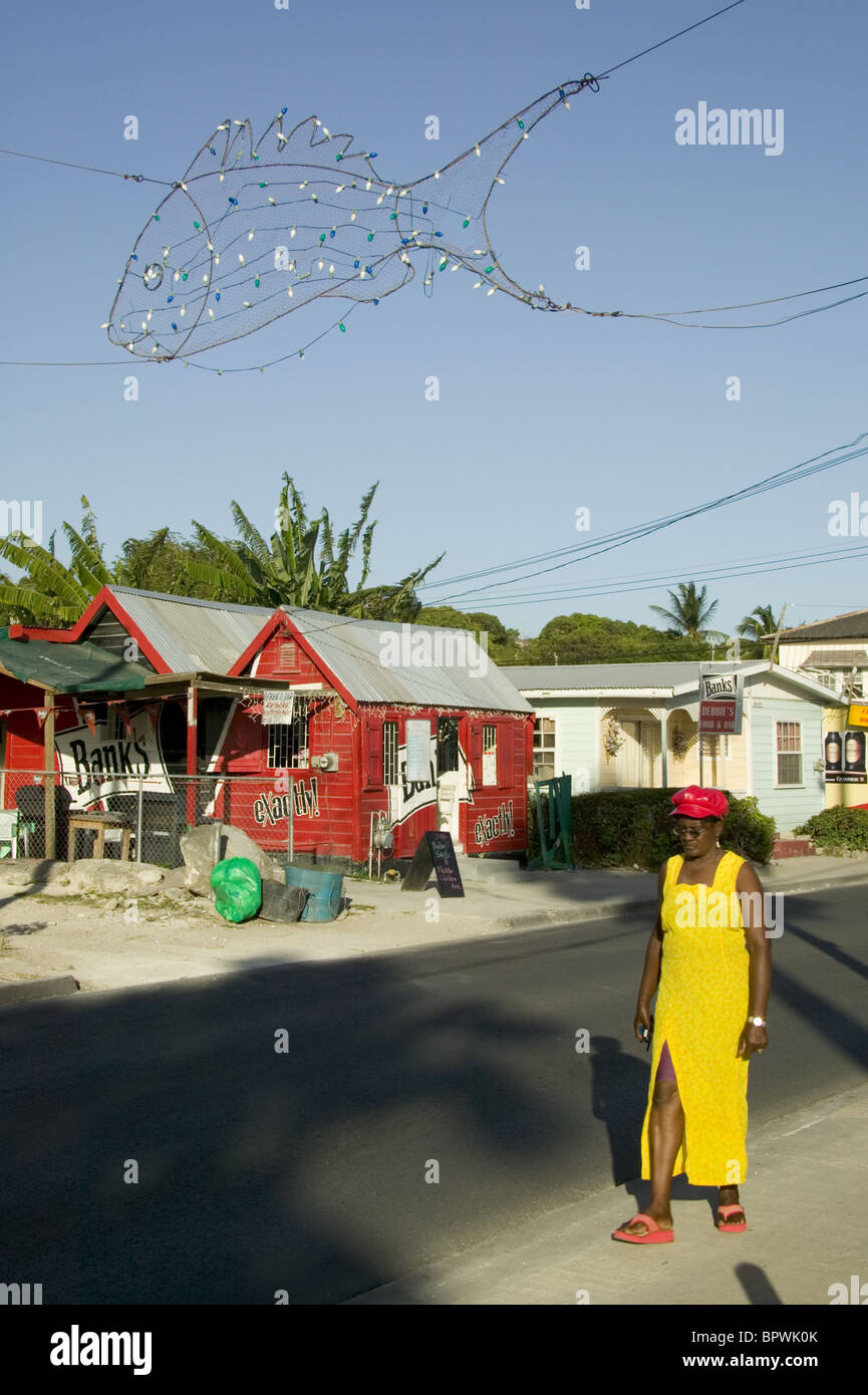 Rumshop and colourfully dressed local at Oistins in Barbados in the Caribbean Islands Stock Photo