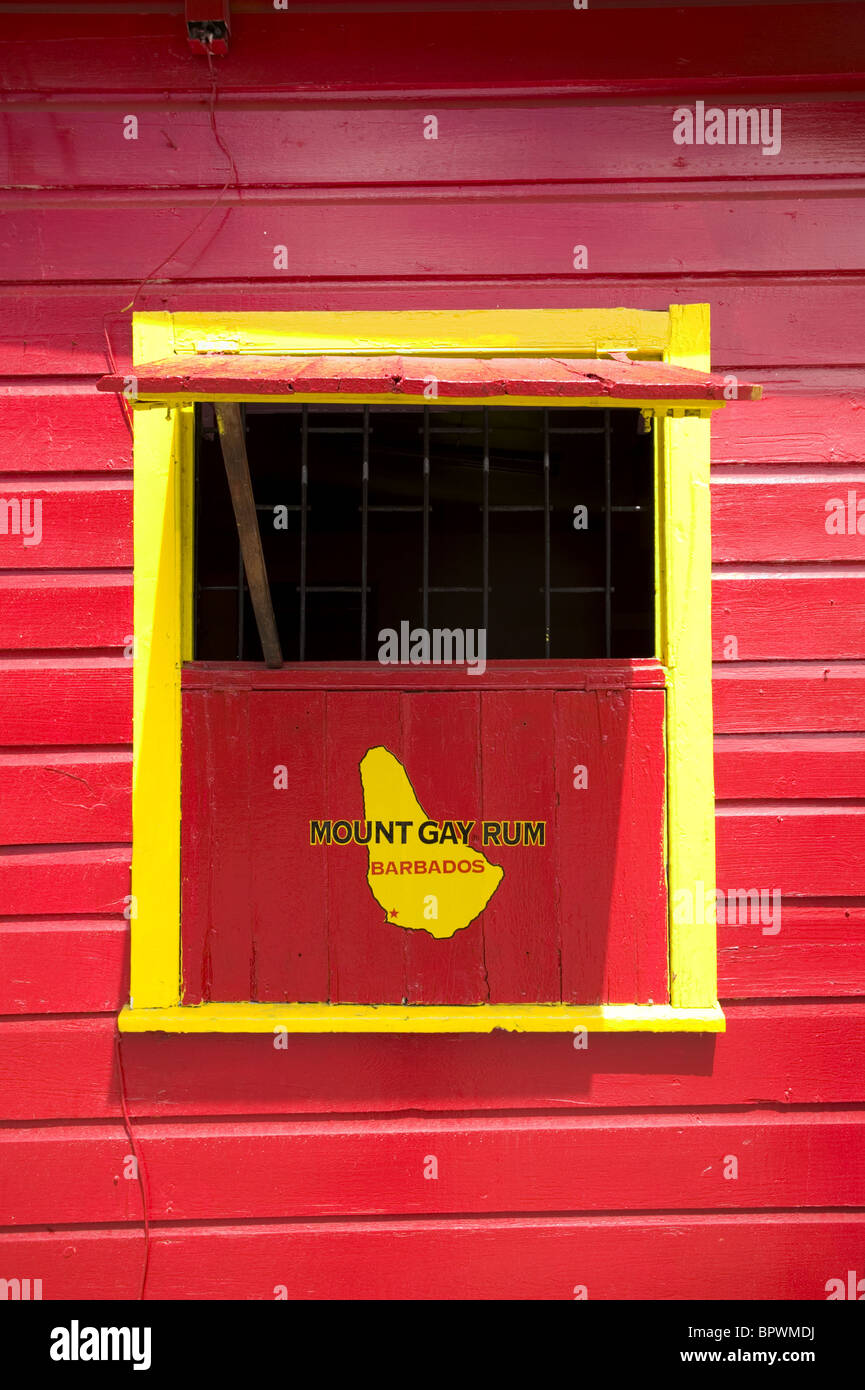 Detail of bright red and yellow rum shop window at Bathsheba in Barbados in the Caribbean Island Stock Photo