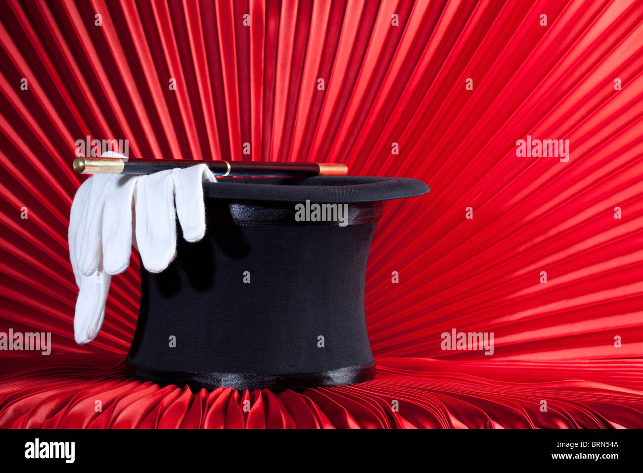 Magician's Top Hat, Wand and Gloves on Red Curtain Stock Photo