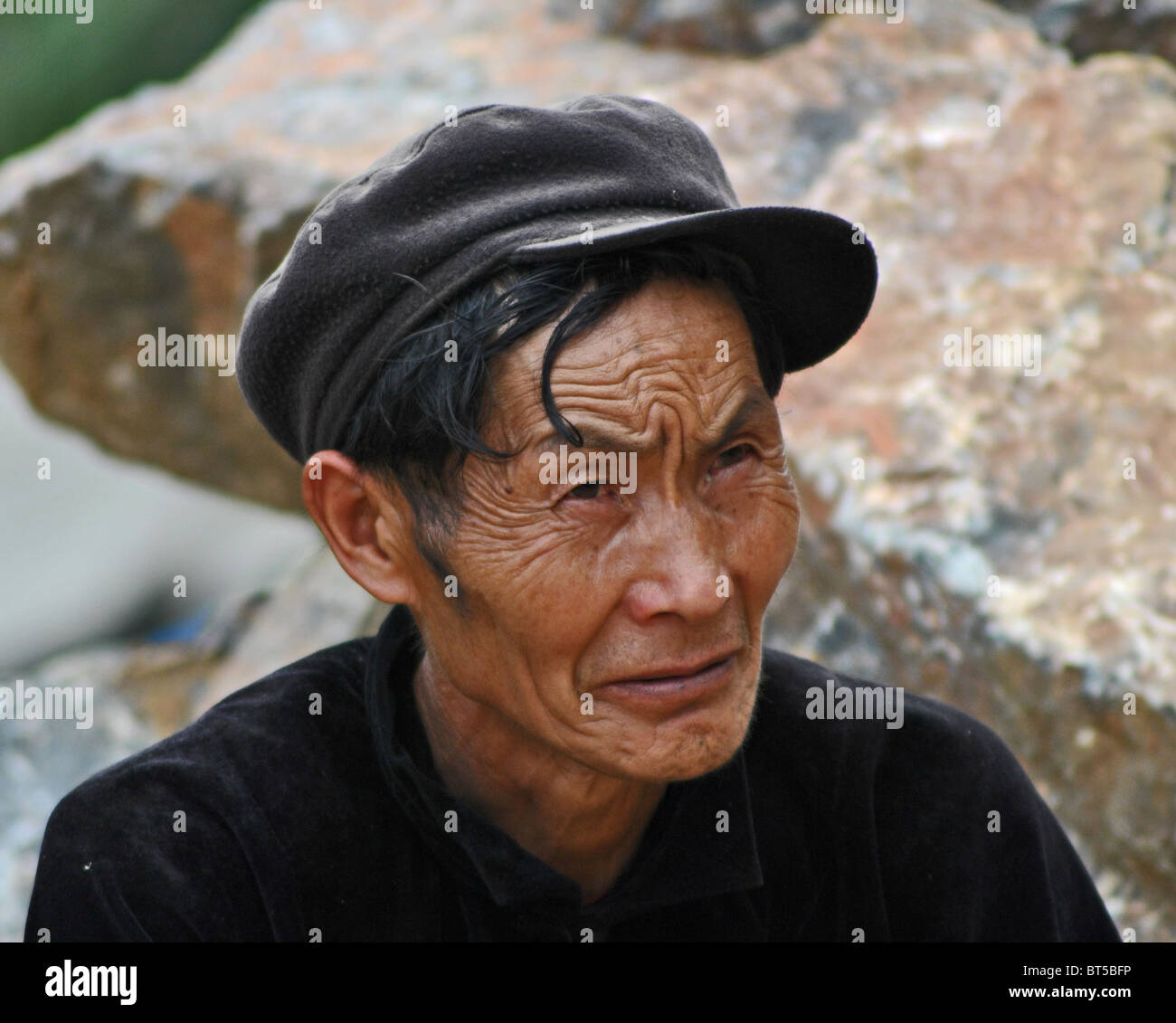 Elderly Vietnamese man with wrinkled face near Sapa, Vietnam Stock Photo