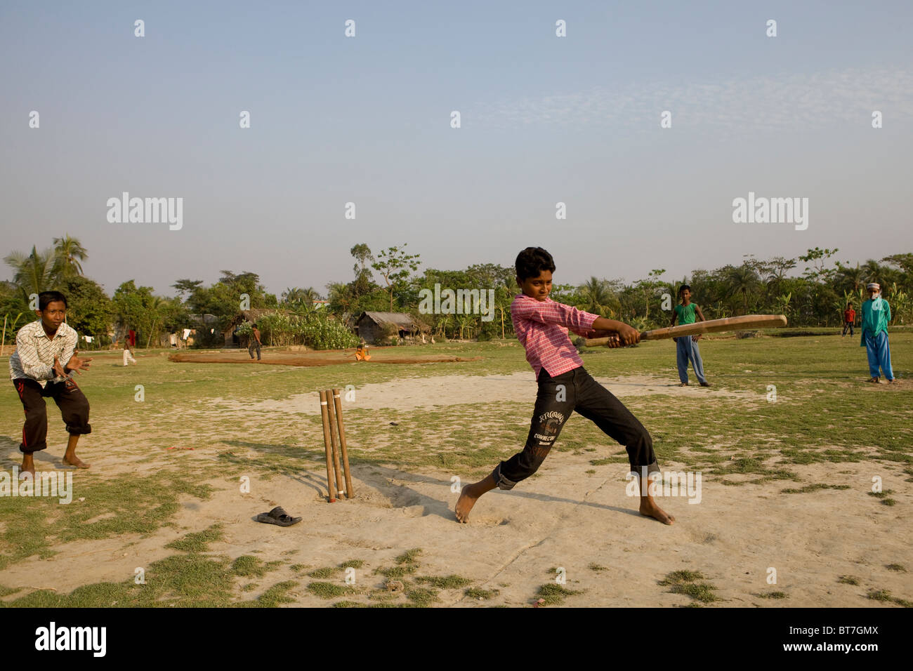 Bangladeshi boys playing cricket in village Stock Photo