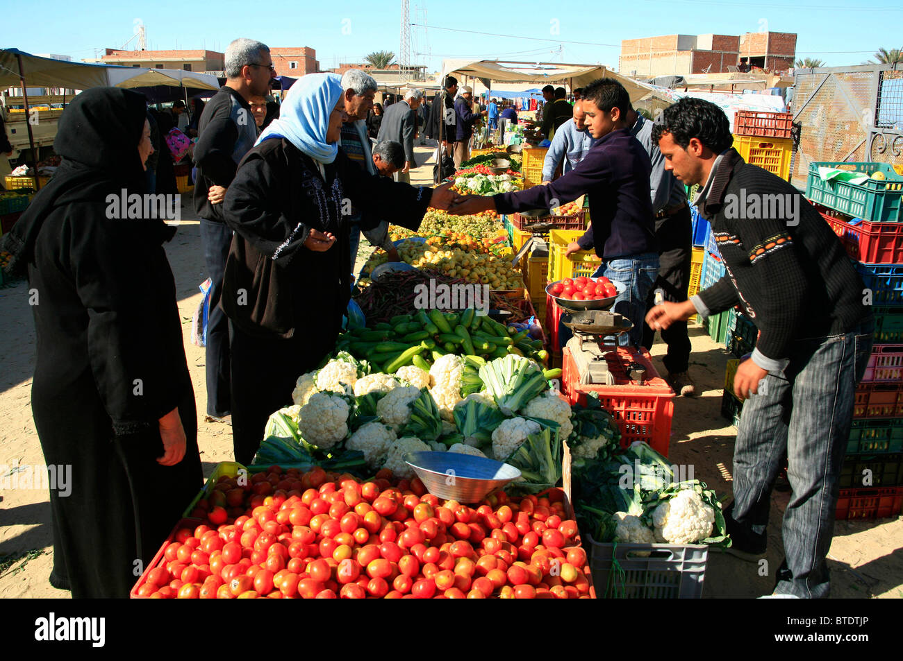 Muslim women buying fruit and vegetables at the local market Stock Photo