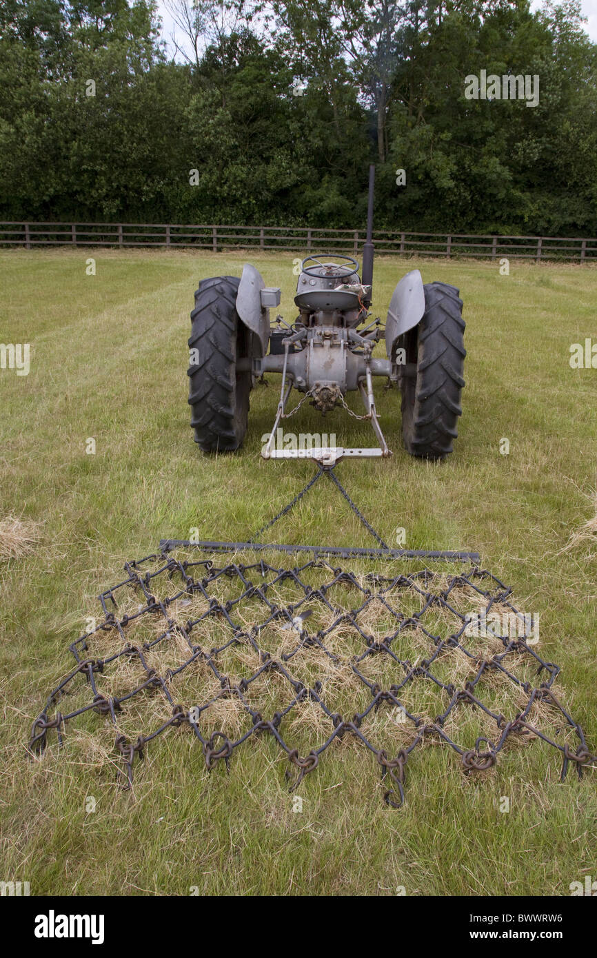 Old grey fergie pulling chain harrow Stock Photo