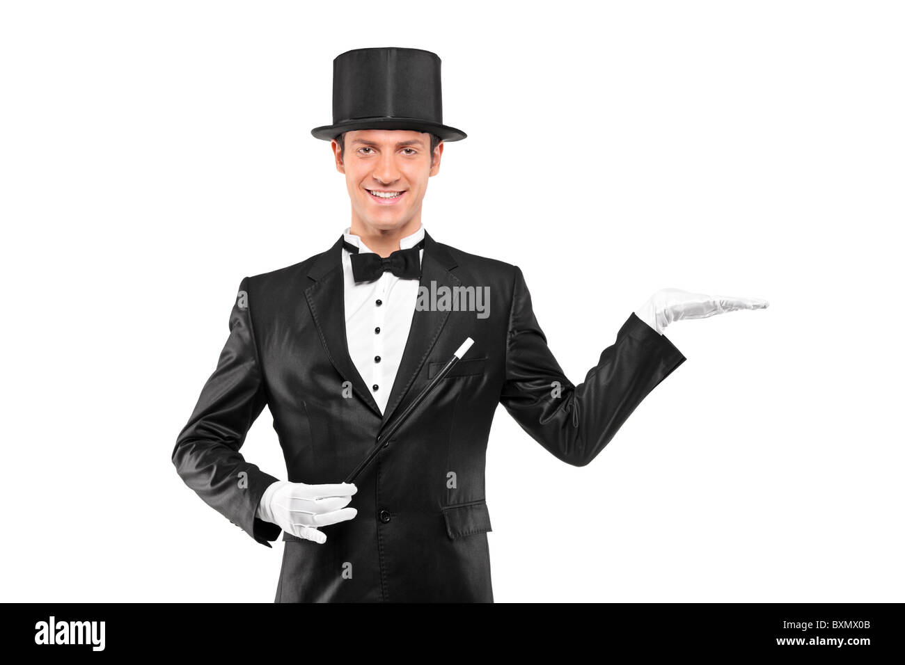 A view of a magician wearing top hat with raised left hand Stock Photo