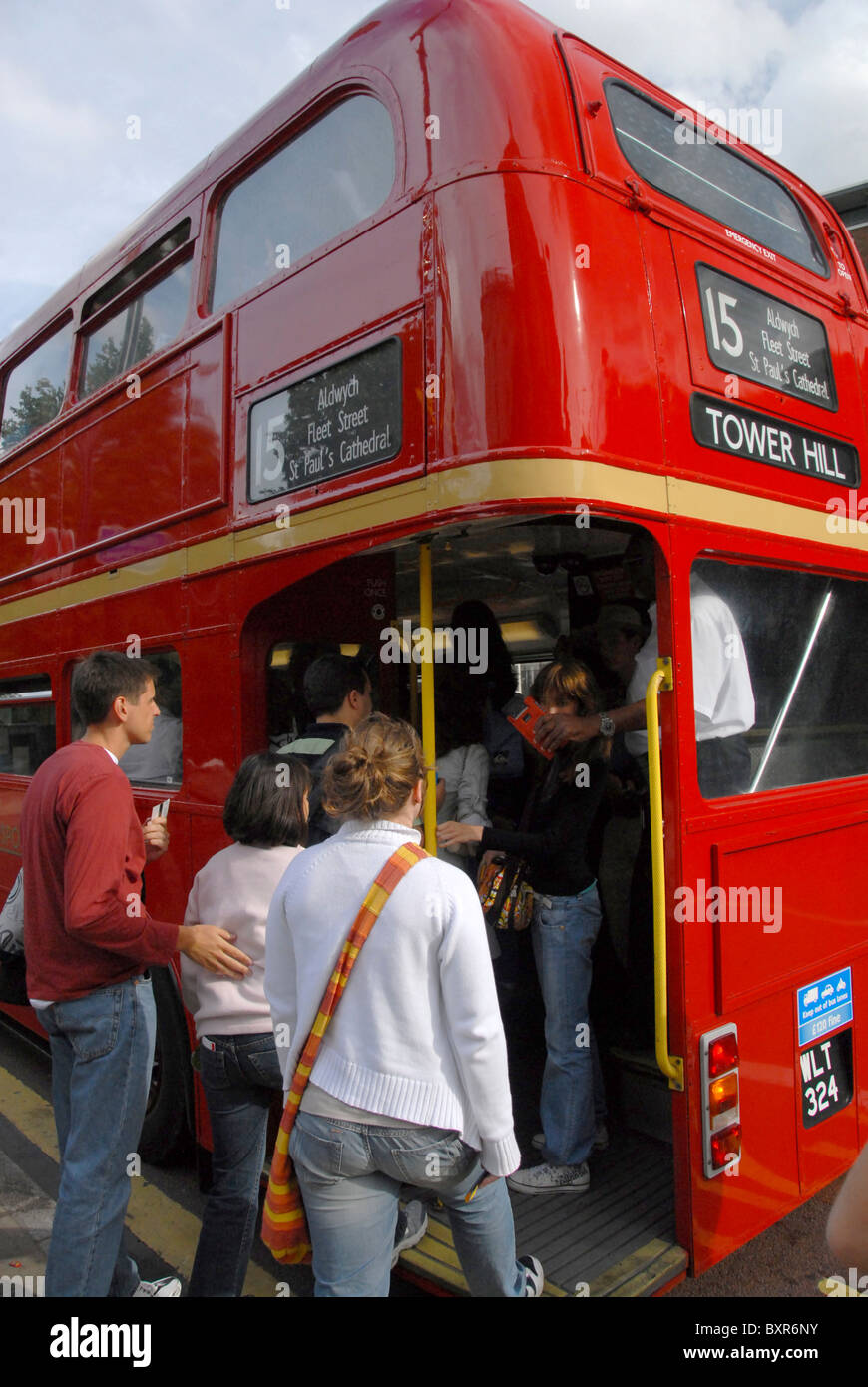 BUS PASSENGERS GET INTO RED DOUBLE DECK BUS Stock Photo