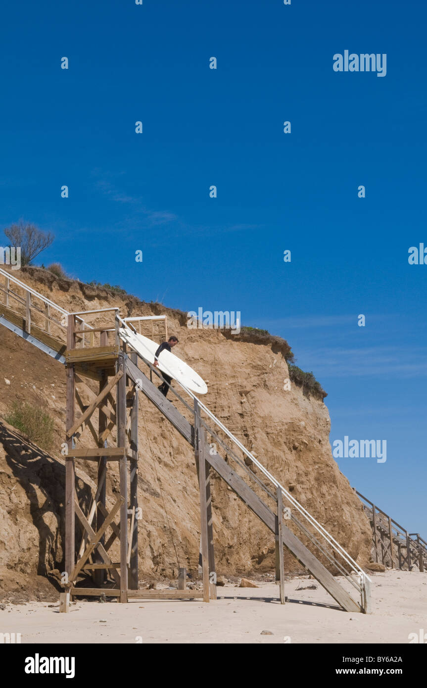 Surfer Descending Access Staircase to Beach Stock Photo