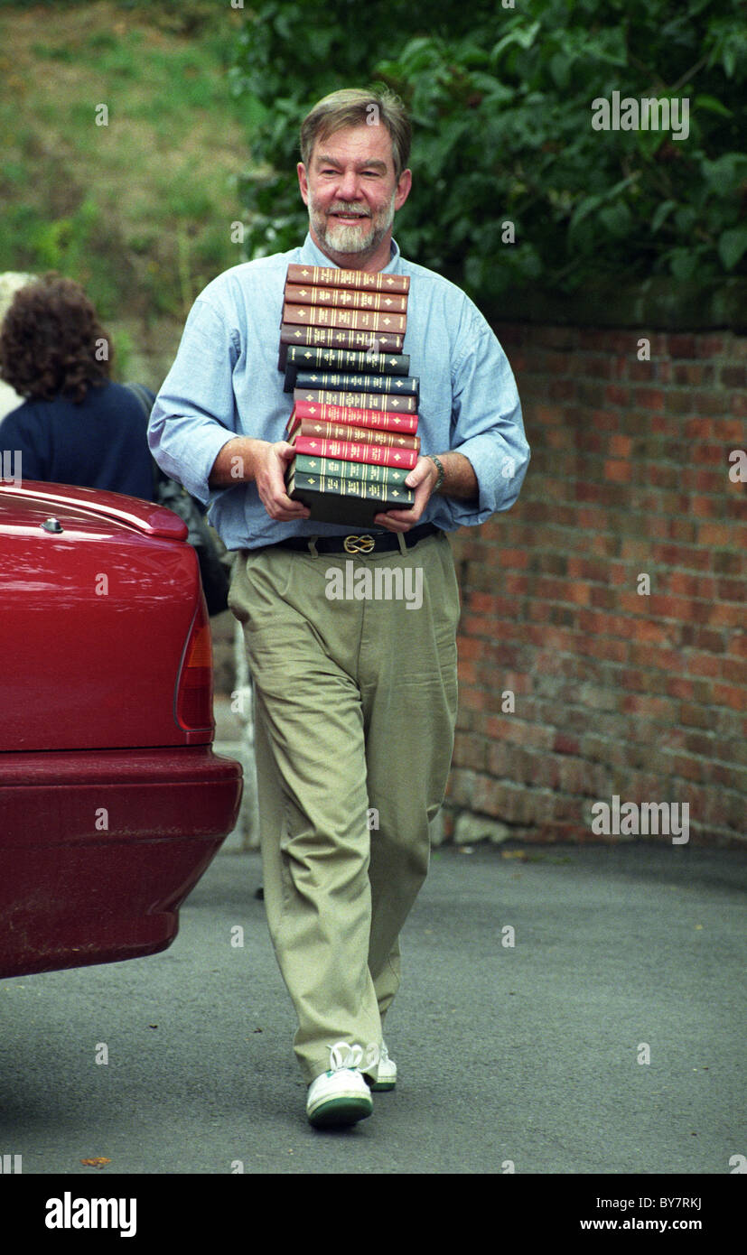 Lord Bradford carrying books to sell at his car boot sale at Weston Park in 1996 Stock Photo