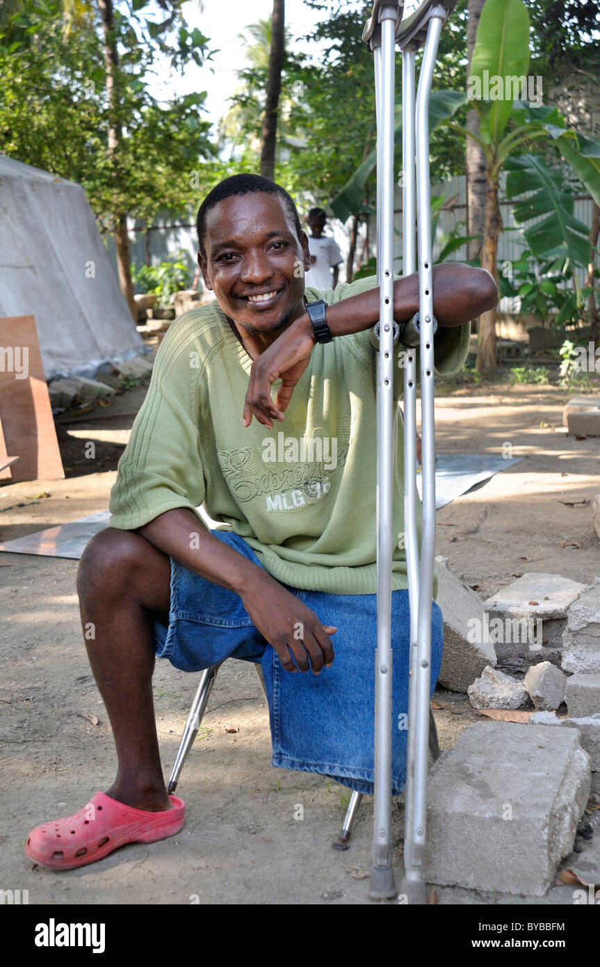 Earthquake victim with amputated leg leaning on his crutches, Port-au-Prince, Haiti, Caribbean, Central America Stock Photo