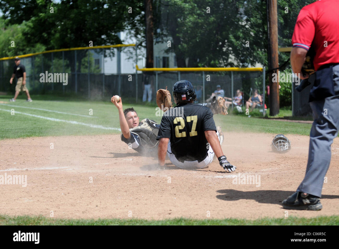 high school baseball game catcher outs base runner USA. Stock Photo