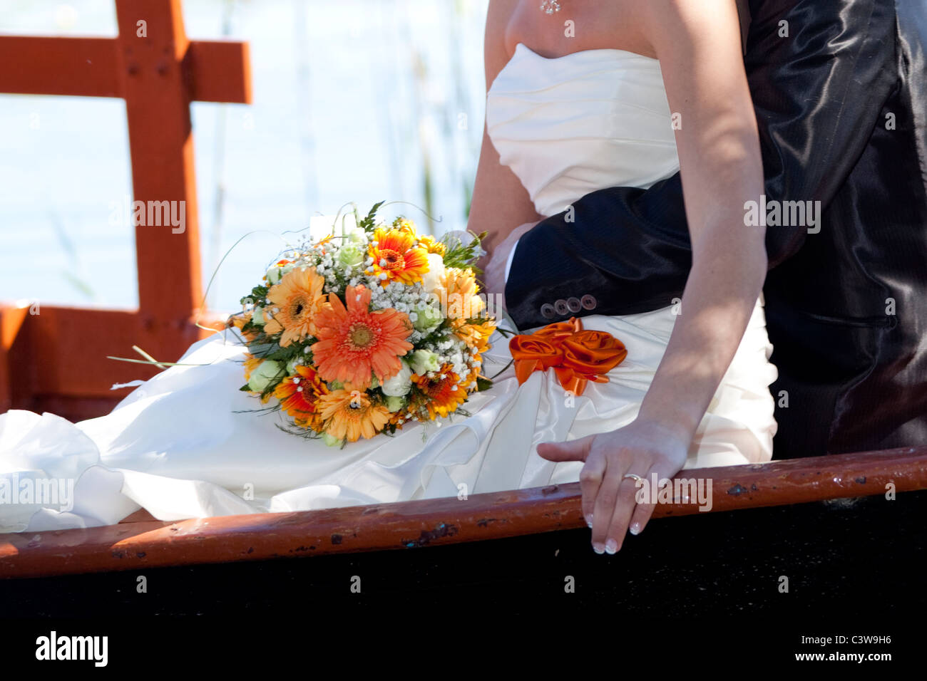 close up of a wedding pair on a boat with bouquet Stock Photo