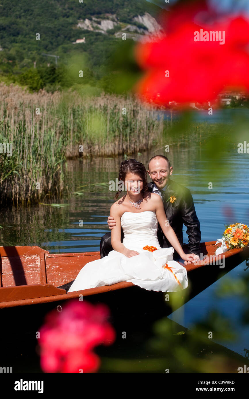 Wedding couple being transported on an old fashion lake Como boat. Stock Photo