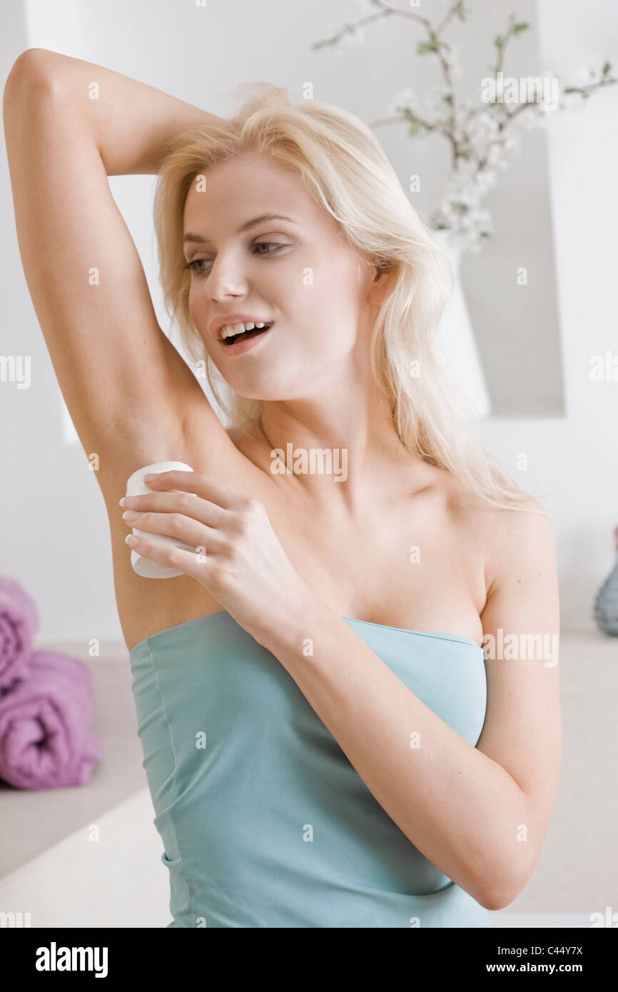 young woman using antiperspirant Stock Photo