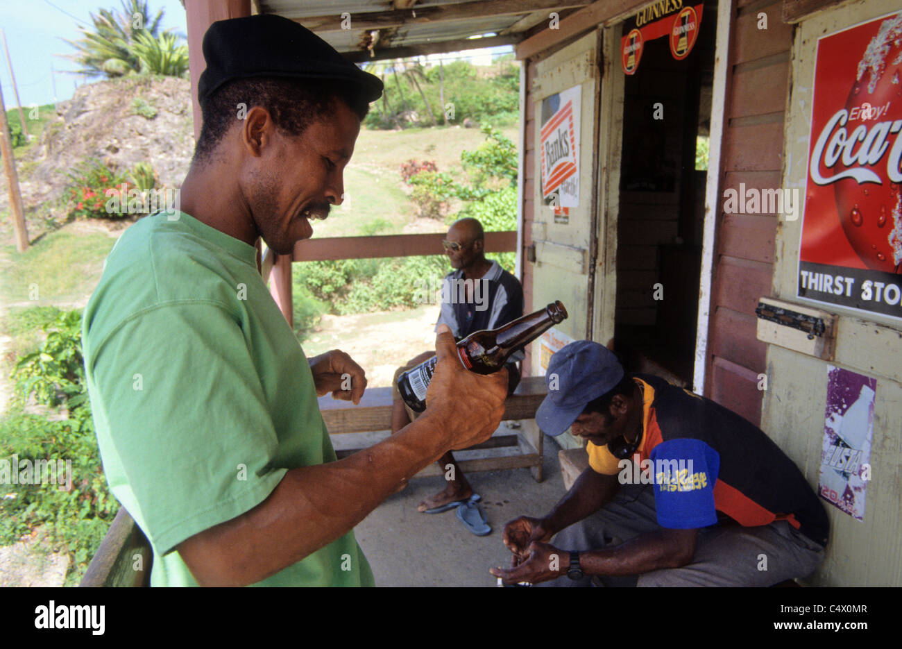 Men relax at a drink shack in Bathsheba on the East coast of  Barbados Stock Photo