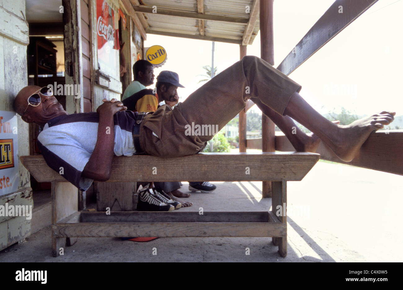 Men relax at a  Rum shack in Bathsheba on the East coast of  Barbados Stock Photo