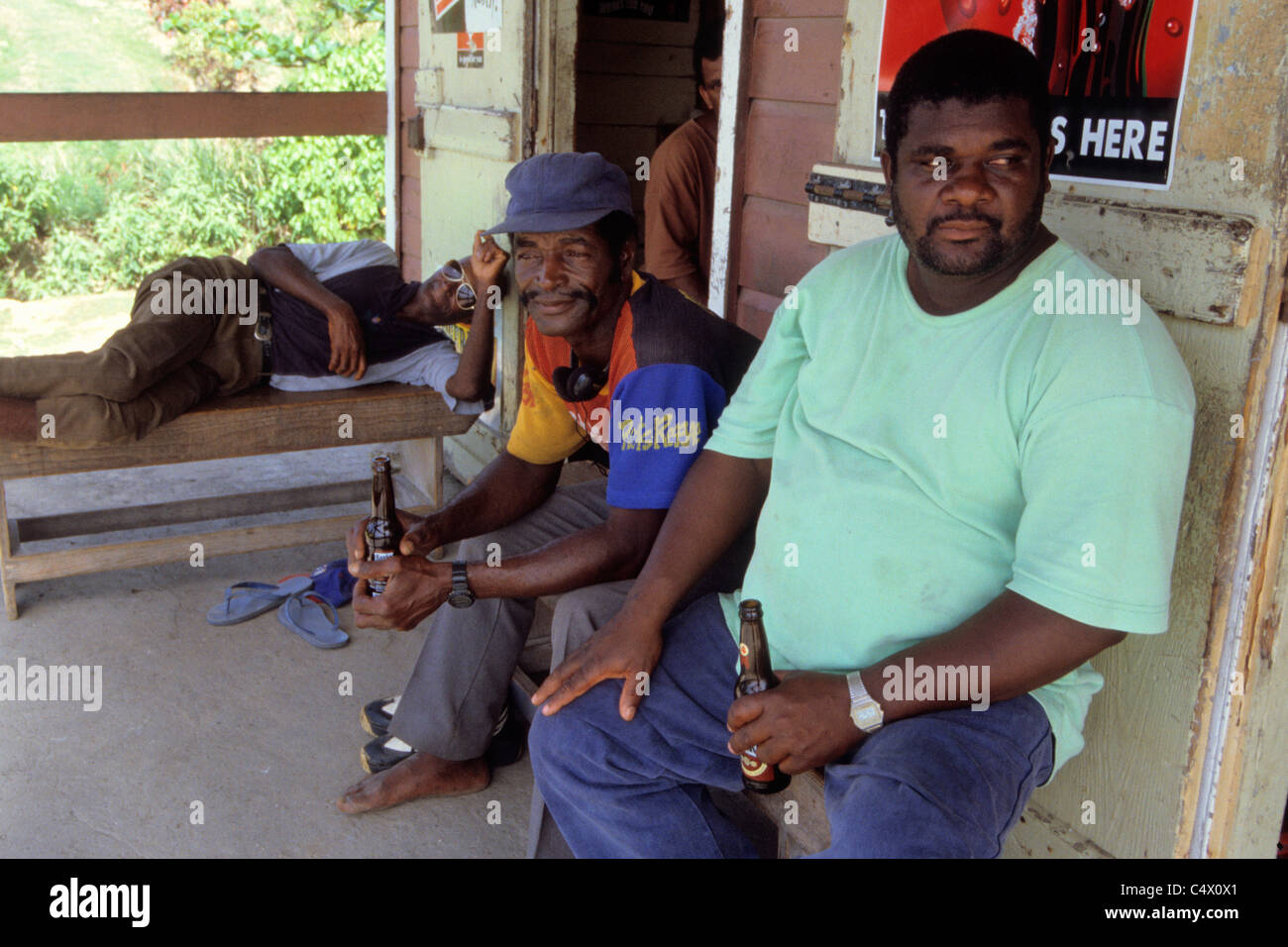 Men relax at a  Rum shack in Bathsheba on the East coast of  Barbados Stock Photo