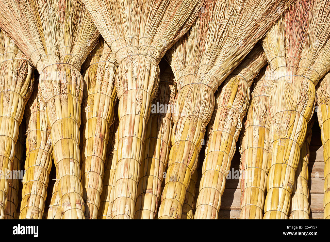 Handmade grass brooms for sale at market, Samarkand, Uzbekistan Stock Photo