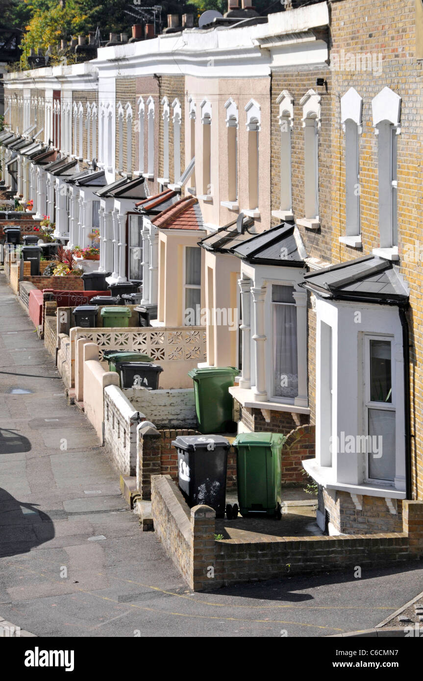 Looking down from above on London street scene of bay window front of terraced houses with Wheelie Bin in front gardens South London England UK Stock Photo