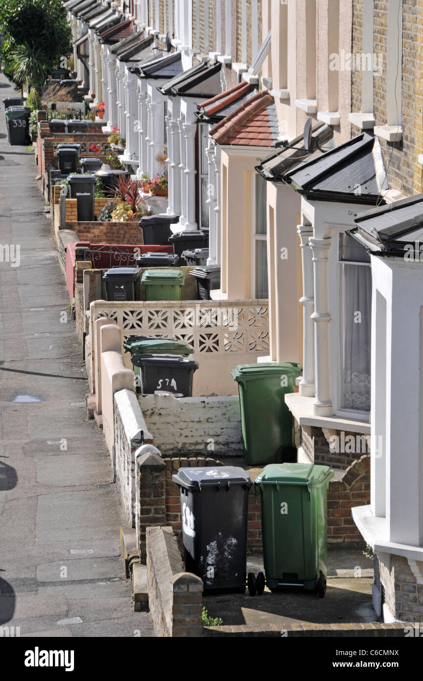 Looking down from above on London street scene of bay window front of terraced houses with Wheelie Bin in front gardens South London England UK Stock Photo