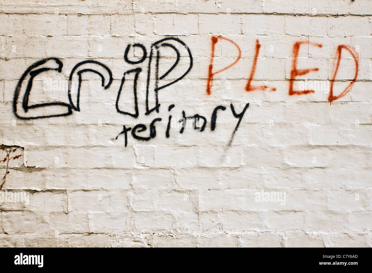 Misspelled gang graffiti in a bad neighborhood Stock Photo