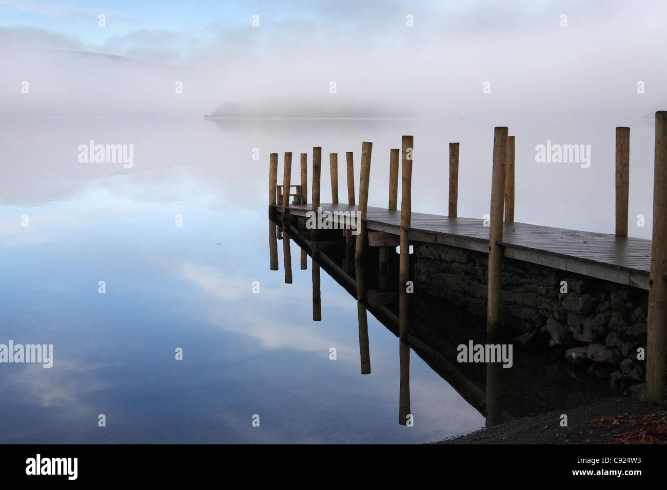 Mist over Derwent water with a wooden Jetty, near Keswick, north west England, UK Stock Photo