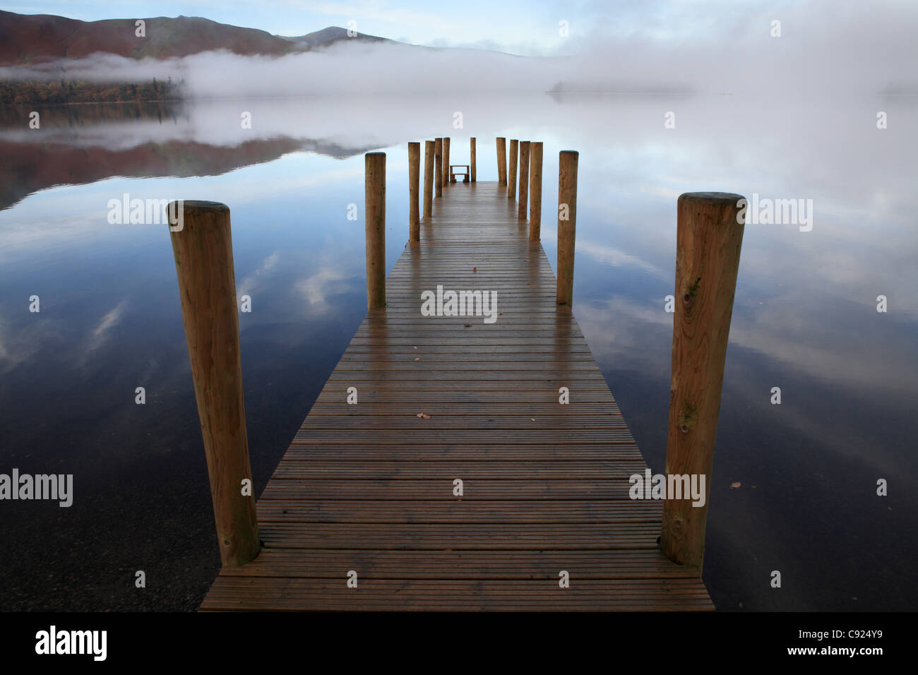 Mist over Derwent water with a wooden Jetty, near Keswick, north west England, UK Stock Photo