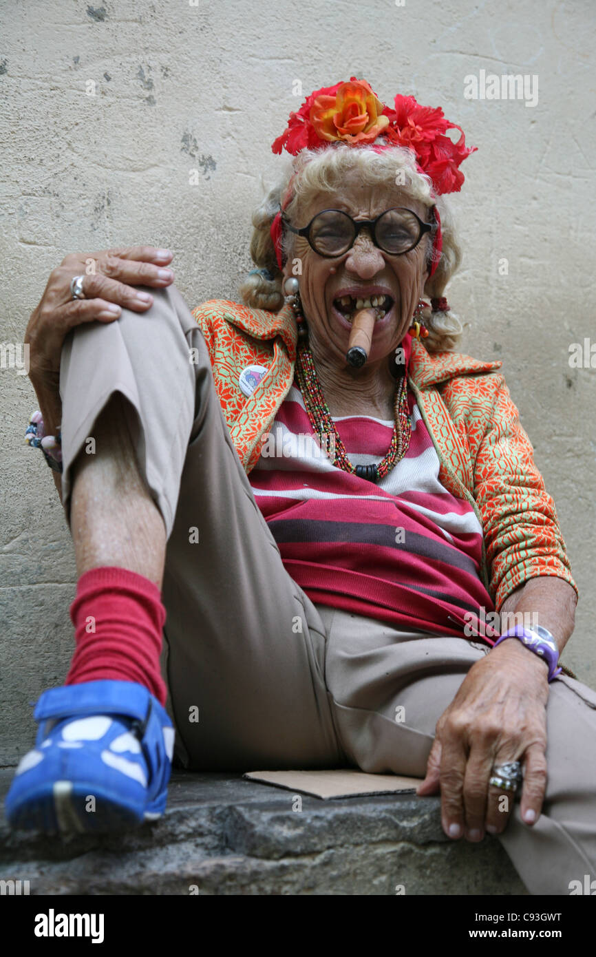 Eccentric elderly Cuban woman Graciela Gonzalez also known as Granny Puretta smokes cigar at age 84 in the historical centre in Havana, Cuba. Stock Photo