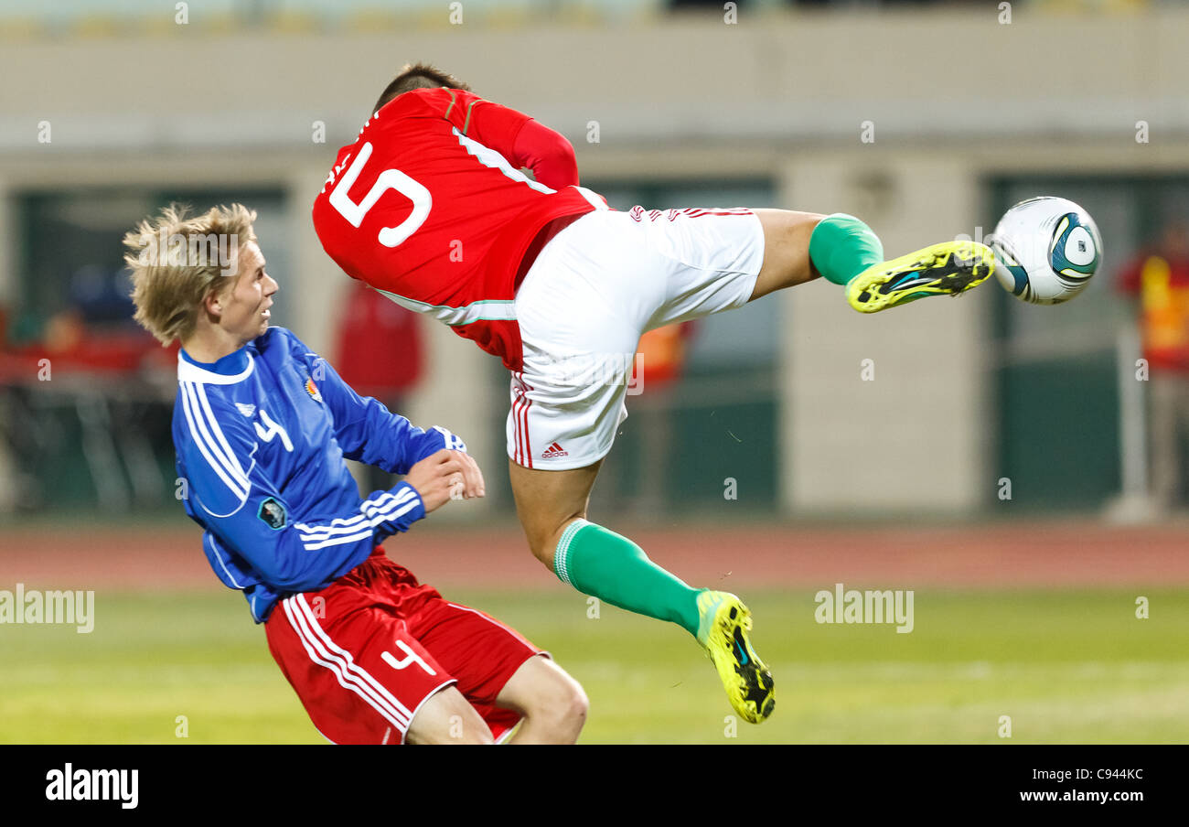 Budapest - November 11: Hungarian Tamas Priskin (R) is scoring a goal, Rechsteiner (4) of Liechtenstein is watching him during Hungary vs. Liechtenstein (5:0) friendly football game at Puskas Stadium on November 11, 2011 in Budapest, Hungary. Stock Photo