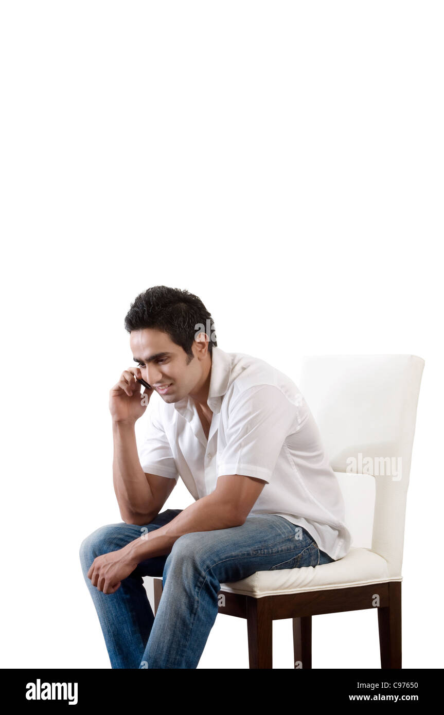 man sitting and talking on phone Stock Photo