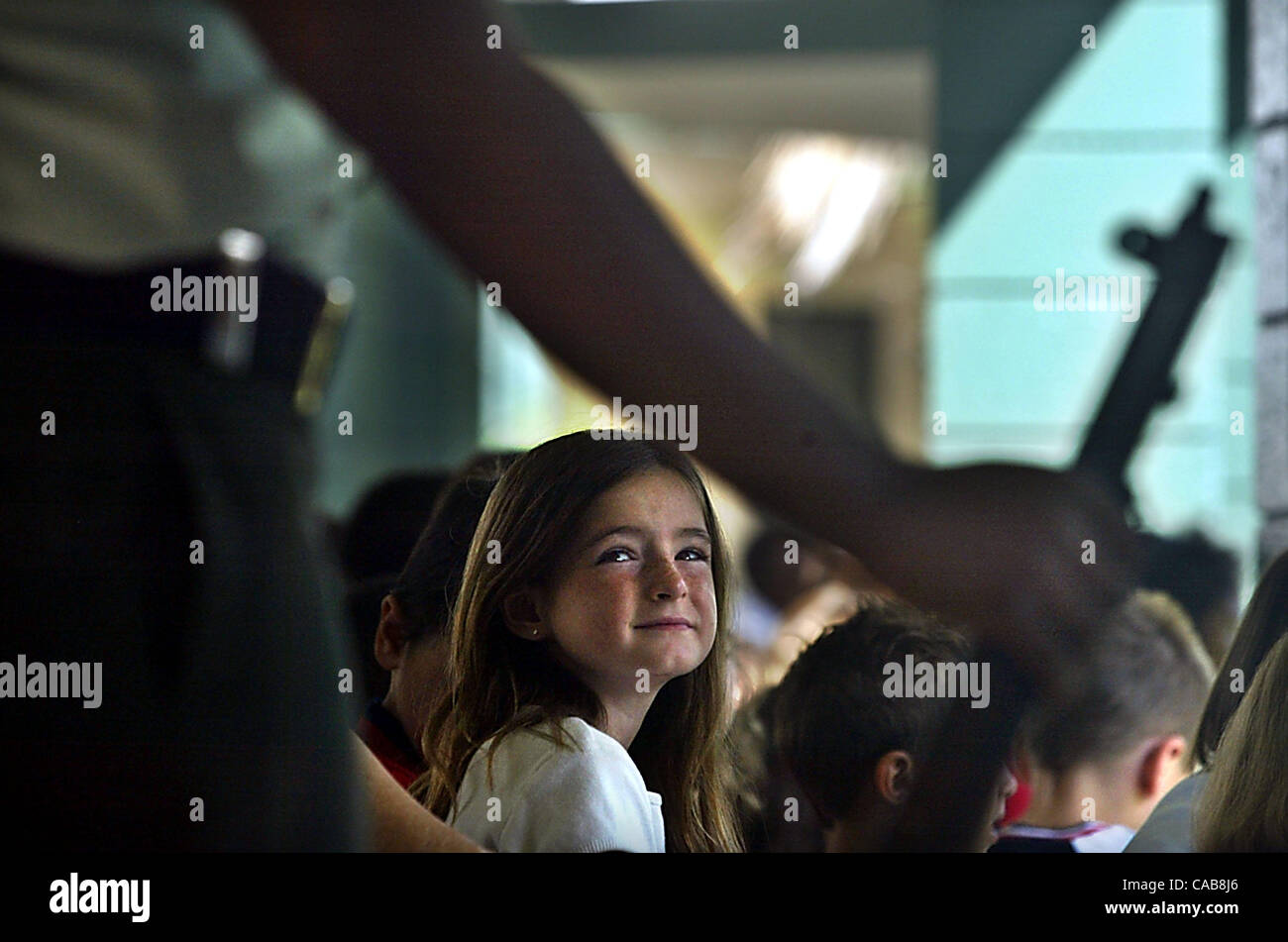 052104 sc met memorial1/3 - BOYNTON BEACH - Hagen Rd. Elementary School (cq) student Danielle LaBome (cq), 7, looks admiringly over her shoulder at the Atlantic High School Army JROTC (cq) standing at parade rest during Memorial Day ceremonies at the Boynton Beach school Friday, May 21, 2004. US arm Stock Photo