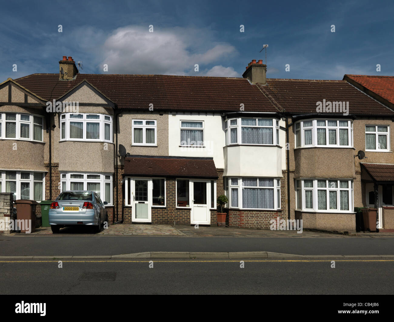 A Row Of terraced Houses With Gardens Paved Over England Stock Photo